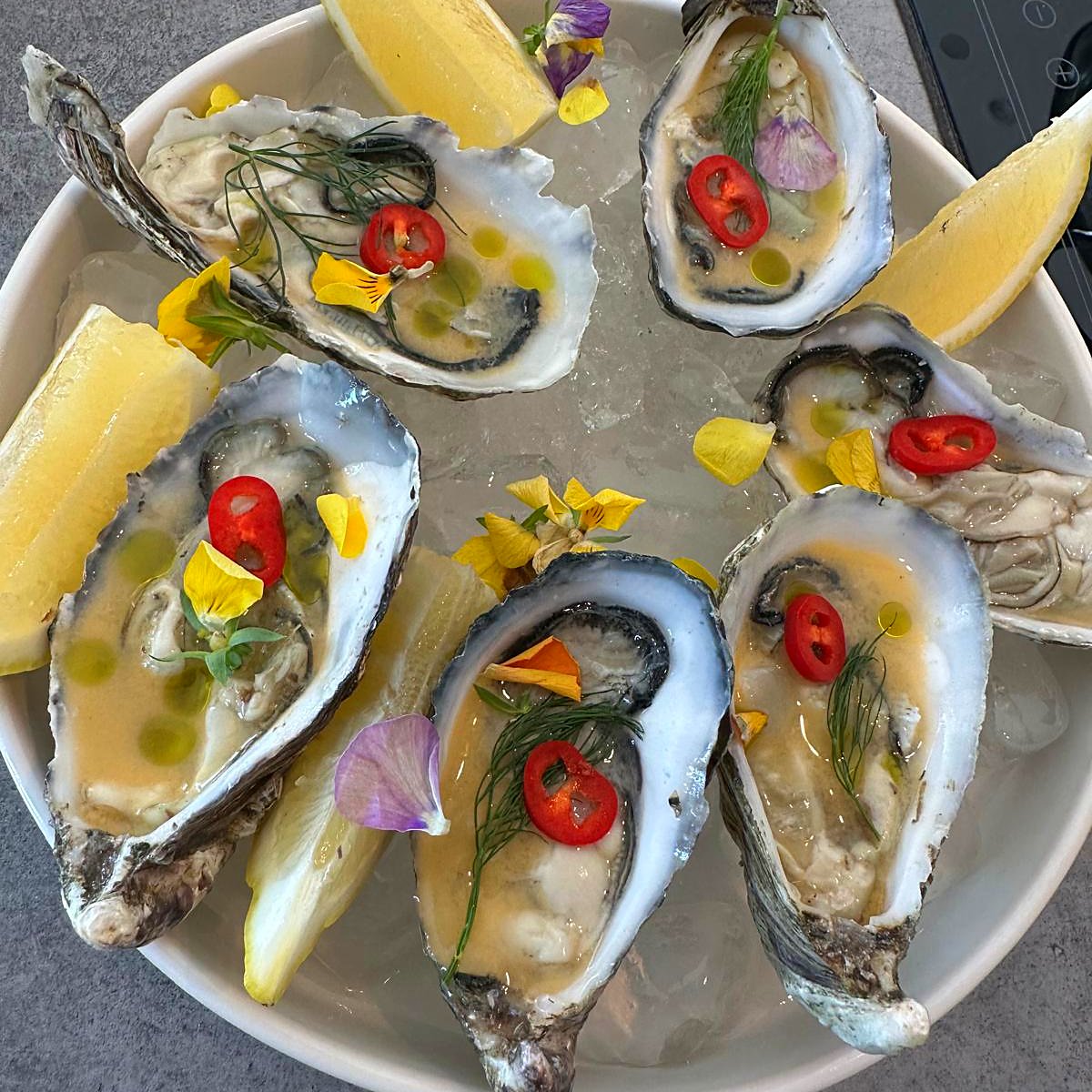 Oysters with chilli and edible flowers