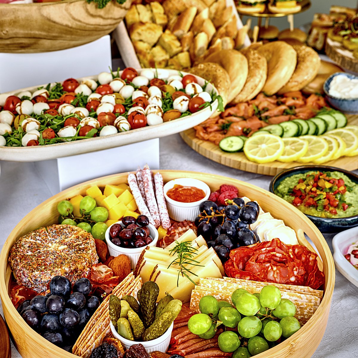A buffet with caprese, fruit and pastries