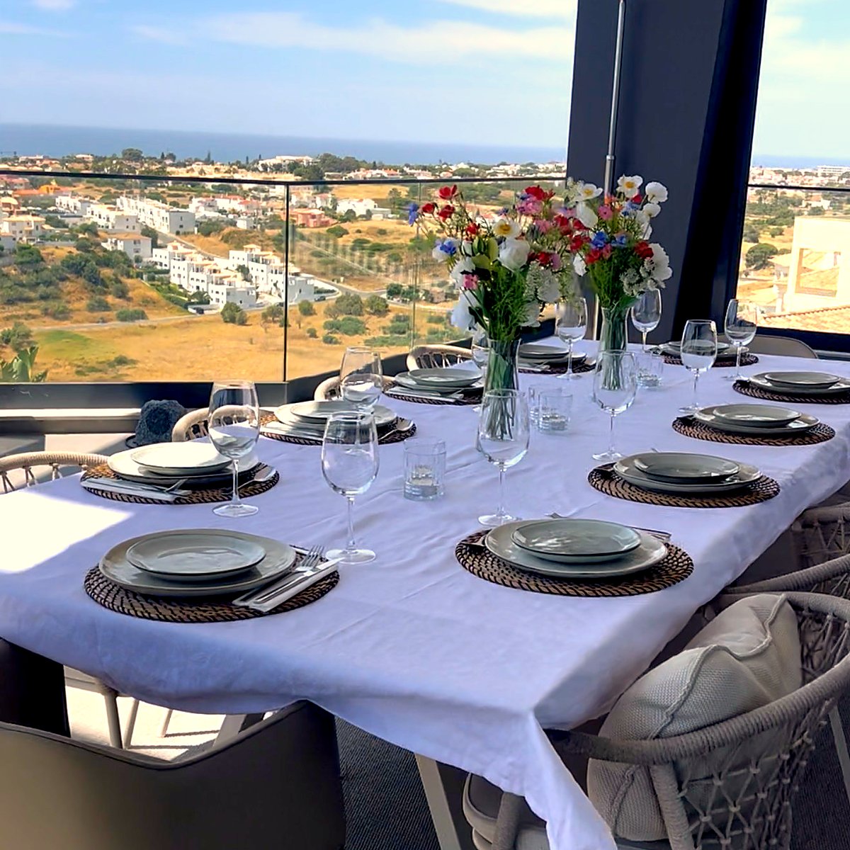 A table laid for dinner with a view over the Algarve