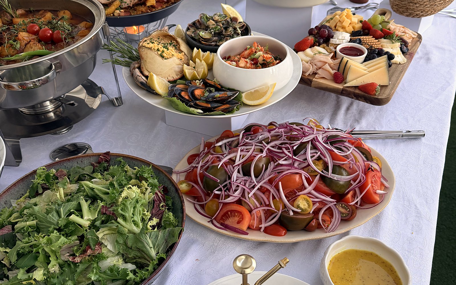 A buffet in a holiday home in Albufeira with salads, mussels and sharing plates