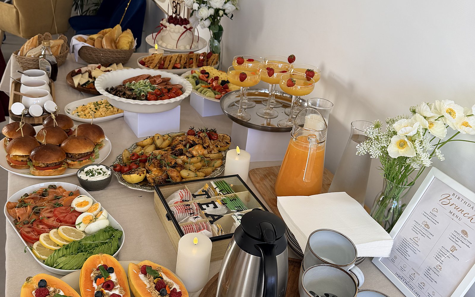 A brunch table in Vilamoura with sliders, pastries and fresh juice